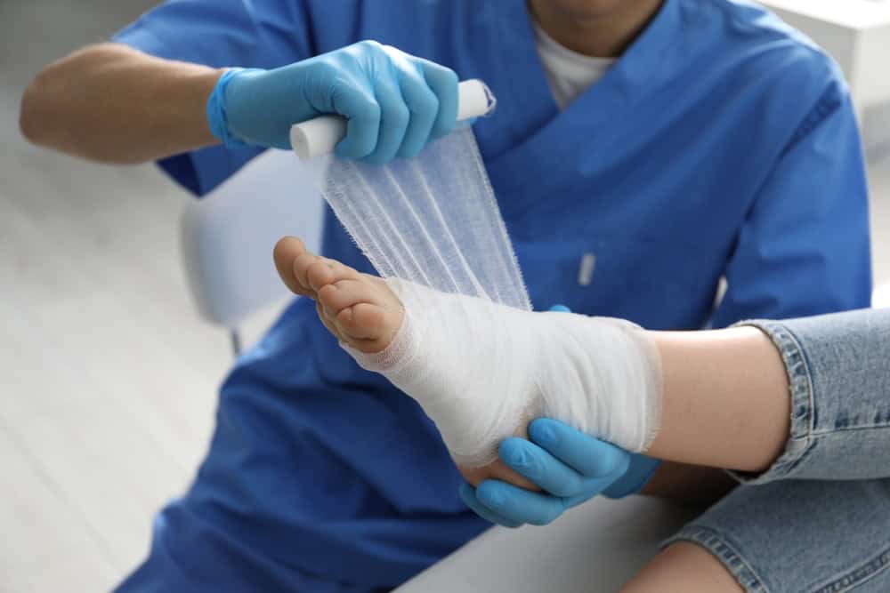 Specialist wraps a foot with sterile gauze as part of care that may shorten chronic wound healing time