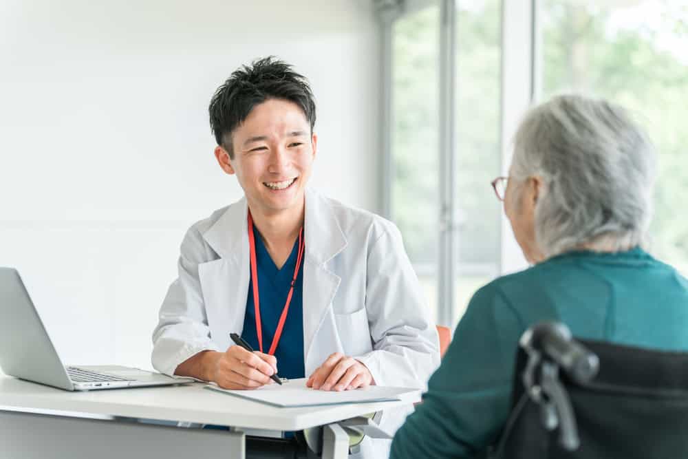 Doctor assessing a diabetic foot wound to explain how to heal a diabetic foot wound