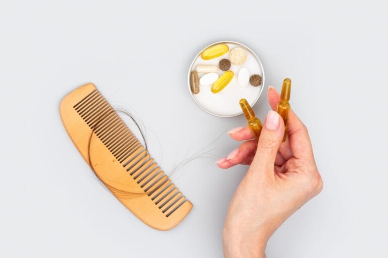 A small plate containing supplements and vitamins for hair growth.