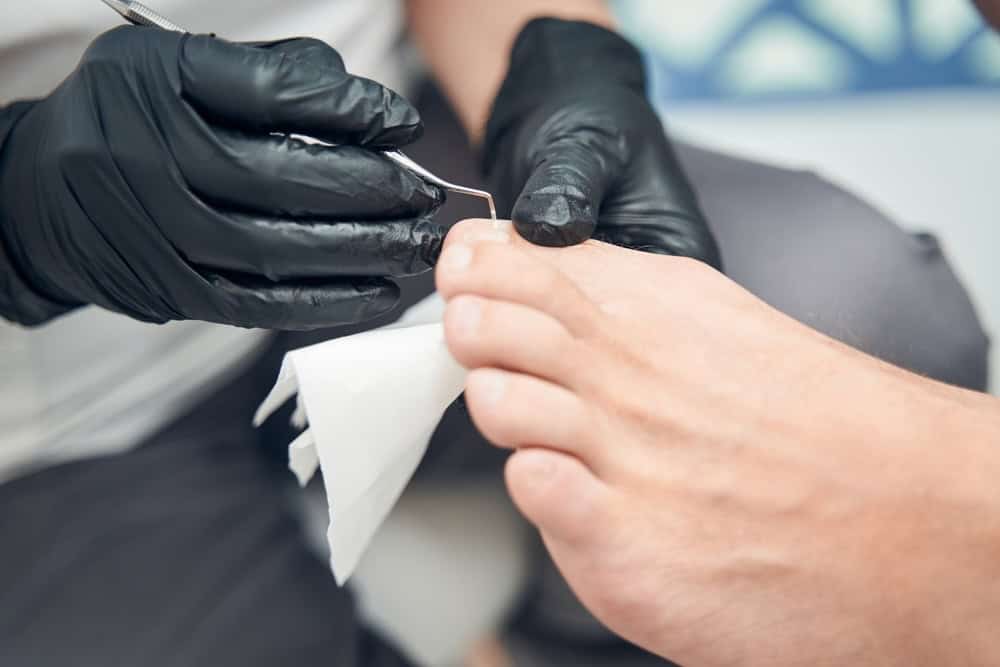 Salon pedicure on a diabetic patient using sterilized tools and gloves