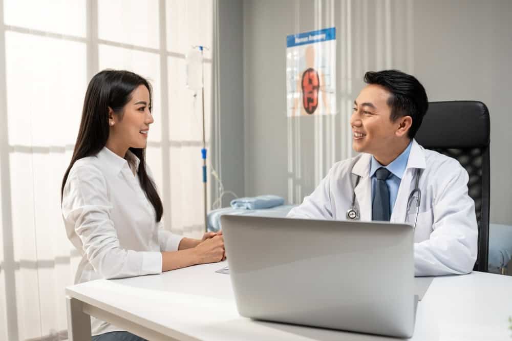 A physician reviewing a treatment plan with a patient as part of physician-led regenerative care.
