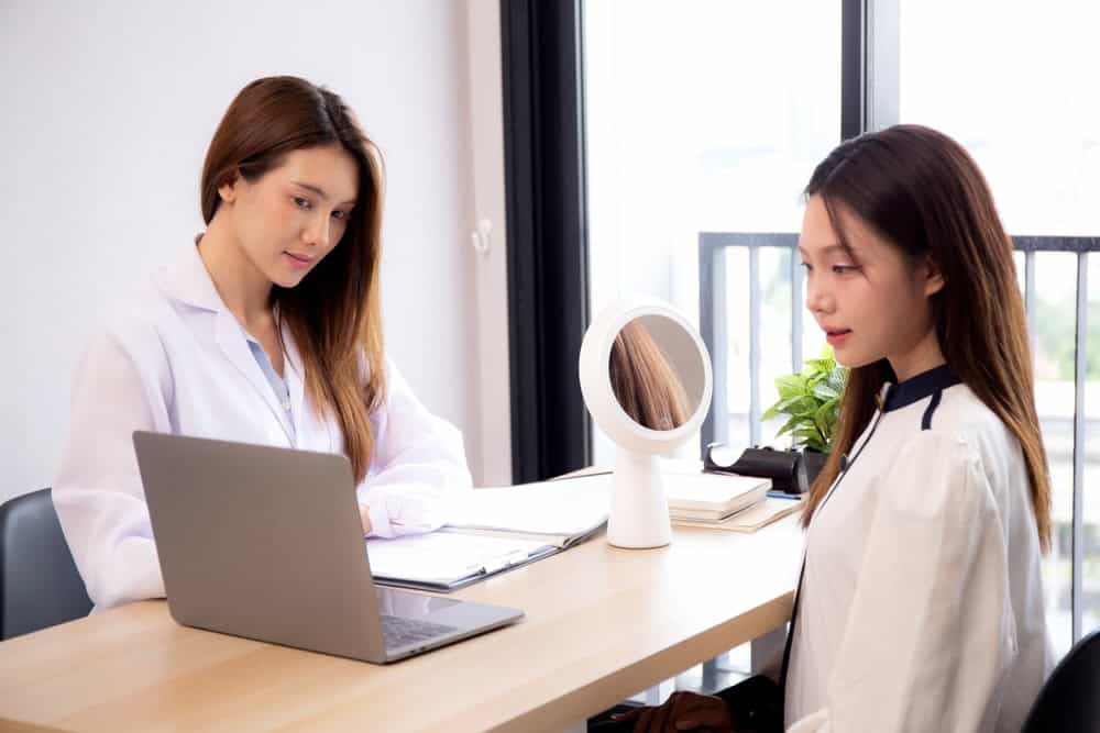 Patient consulting a doctor about stem cell therapy for skin rejuvenation